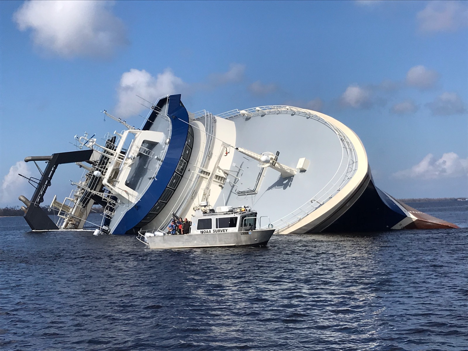 sunken vessel with navigation response team vessel in foreground