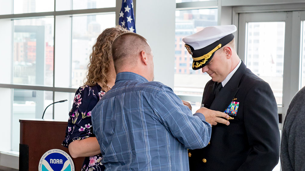 Capt. Chris van Westendorp’s command pin is transferred by his best friend.